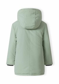 Veste à capuche vert clair avec une texture lisse, détails de couture à l'avant, coupe ample et accents de poignets noirs. Vue arrière mise en avant.