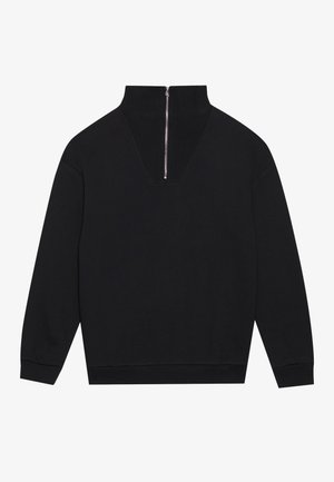 Čierny pulóver so striedavým golierom, dizajn v tvare V na zadnej strane a strieborný zips. Mäkkučká látka a voľný strih.