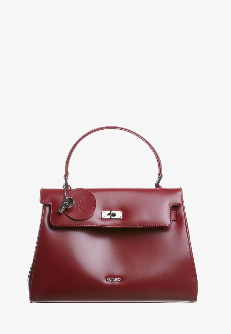 Borsa a mano in pelle bordeaux lucida con manico superiore, chiusura a scatto argentata e etichetta rotonda in pelle con il nome del marchio.