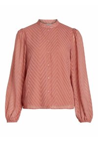 Blouse de couleur pêche avec un col haut, de longues manches ballon et un motif en chevrons. Présente des fermetures à boutons sur le devant. Tissu texturé.