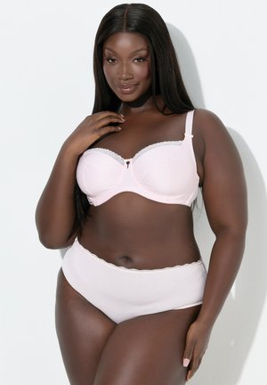 Lichtroze beha met stippenstructuur, kantafwerking en strikdetail; bijpassende lichtroze hooggekruiste slip met geschulpte randen.