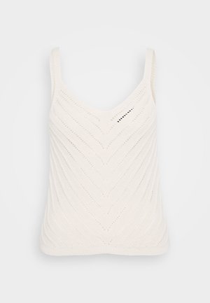 White knitted tank top with a V-neck, featuring a chevron pattern and thin straps. The texture is lightweight and airy.