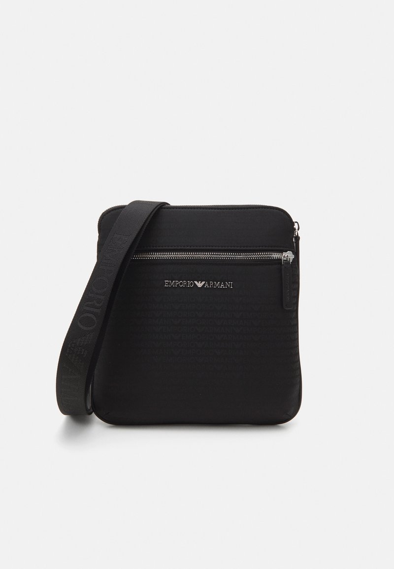 Black messenger bag with a textured design, featuring a front zip pocket and an adjustable strap. Embossed logo detail on the front.