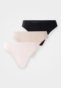 Three pairs of Calvin Klein thong underwear in black, beige, and light pink, neatly arranged on a white background.