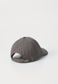 Dark gray cotton cap with a curved brim, adjustable strap at the back, and subtle stitching details on the crown.