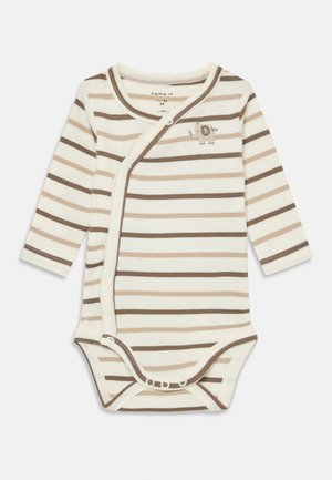Tutina a maniche lunghe a righe in crema e marrone, con chiusura a scatto e un piccolo design di elefantino sulla parte anteriore. Tessuto morbido e a coste.