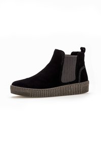 Schwarze Wildleder-Ankle-Boots mit elastischen Seitenpaneelen, strukturiertem Gummisohle und kontrastierenden Nähten entlang der Kanten.