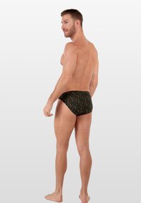 Herren Schwimmbereich in dunkelgrünem Stoff mit einem Blattmuster. Entworfen für einen eng anliegenden Sitz, mit einem elastischen Bund und minimaler Abdeckung.