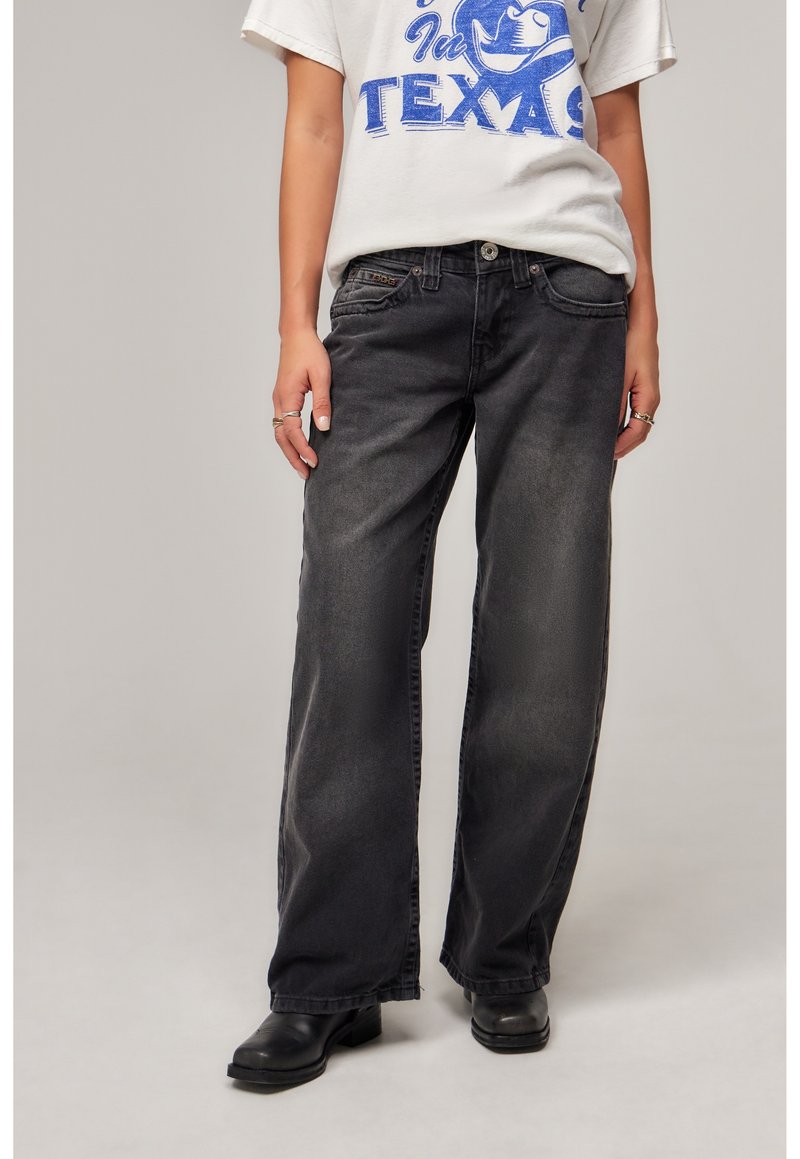 Black wide-leg denim jeans with a faded finish, featuring a five-pocket design and a button-and-zip fly closure, paired with black ankle boots.