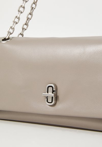 Beige leather handbag with a smooth texture, featuring a silver metal clasp and a chain strap. Simple rectangular design with minimal detailing.