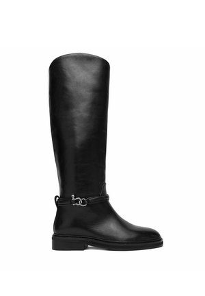 Black knee-high leather boot with low heel and decorative strap with silver metal buckle around the ankle.