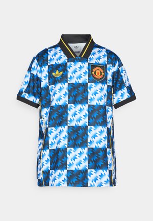 Plave i bijele šare na nogometnoj majici s crnim ovratnikom, žutim detaljima i logotipom Manchester Uniteda na prsima.