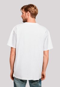 White cotton t-shirt with short sleeves, a relaxed fit, and a crew neckline. Minimalist design, no visible logos or patterns.