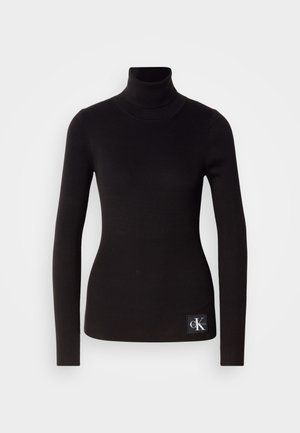 Schwarzer, gerippter Rollkragenpullover mit langen Ärmeln und taillierter Silhouette; mit einem Logo-Patch an der unteren linken Seite.