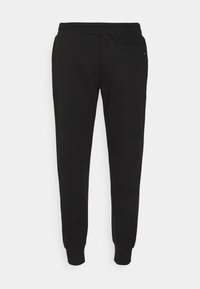 Svarta slim-fit joggerbyxor med elastisk midja och muddar vid anklarna, med en enda bakficka på högra sidan.