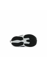 Semelle de chaussure de sport noir et blanc, présentant des motifs texturés et des formes curvilignes pour une meilleure adhérence. Le matériau en caoutchouc assure la durabilité.