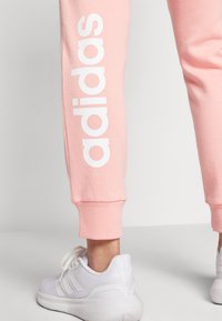 adidas Sportswear ESSENTIALS LINEAR CUFFED - Treniņtērpa apakšdaļas - semi pink spark