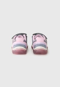 Children's sneakers with a gray and pink synthetic upper, adjustable strap, and transparent pink sole. Rounded design with textured accents.