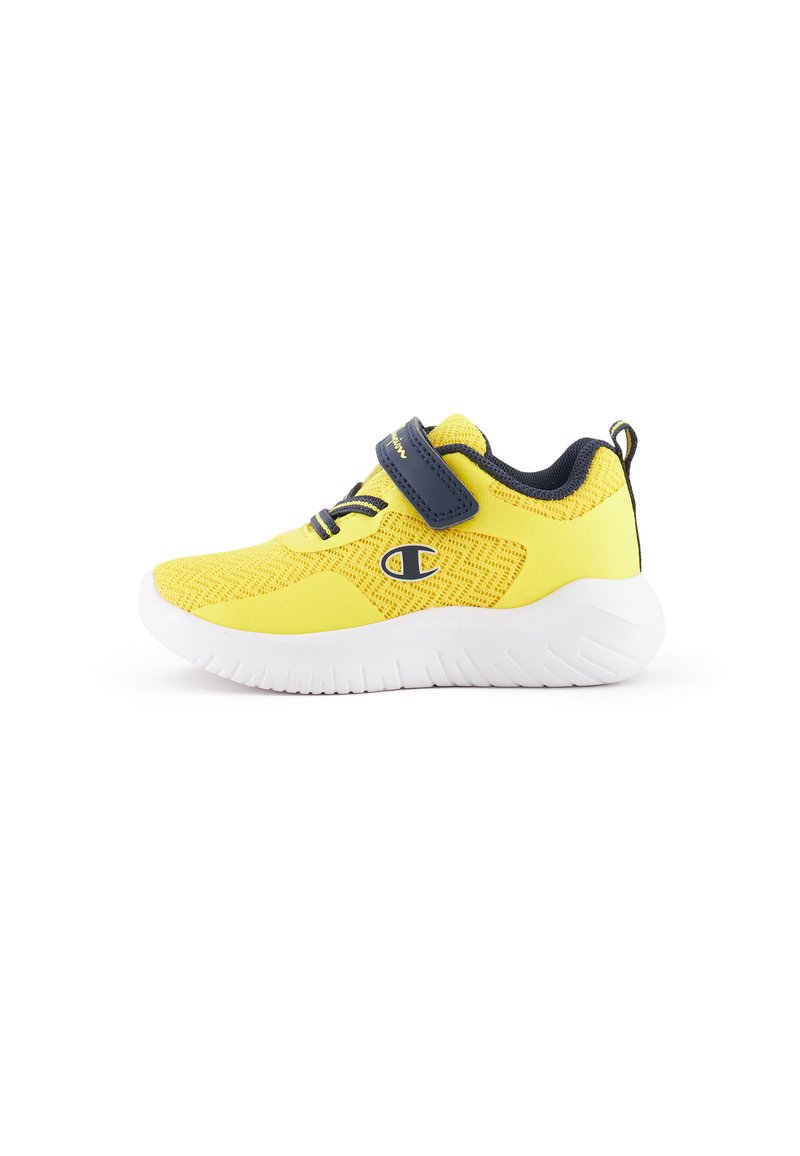 Zapatilla deportiva amarilla con parte superior de malla, talón reforzado, suela de goma blanca, correa de Velcro y acentos contrastantes en azul marino.
