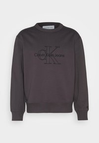 Donkergrijze sweatshirt van katoen, met een ronde hals, lange mouwen en een reliëf zwart Calvin Klein Jeans-logo op de voorkant.