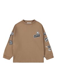 Brun långärmad t-shirt med olika svarta lappar med grafik och text. Tillverkad av mjukt material, rund halsringning, avslappnad passform.