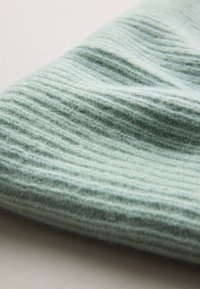 Light blue ribbed textile with a soft, fuzzy texture, displaying subtle variations in shading and depth.