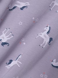 Purple fabric featuring a repeated pattern of white unicorns with black manes and red accents, interspersed with small white stars.