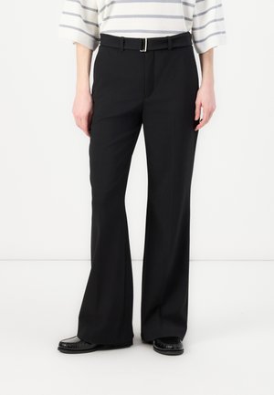 Black, high-waisted trousers with a straight-leg design, featuring a silver buckle belt and smooth fabric texture. Worn with a striped top.