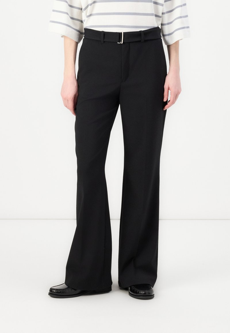 Black, high-waisted trousers with a straight-leg design, featuring a silver buckle belt and smooth fabric texture. Worn with a striped top.