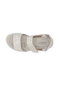 Beige leather sandal with two adjustable Velcro straps, open toe, and cushioned footbed, featuring a textured insole and supportive sole.