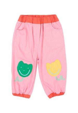 Pantaloni rosa per bambini con fascia elastica arancione in vita e polsini, decorati con toppe a forma di fiore sorridente verde e giallo sulle ginocchia.