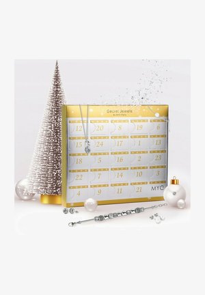 Calendario dell'Avvento di gioielli in oro e argento con porte numerate, che presenta una collana d'argento e elementi decorativi natalizi come un albero e ornamenti.