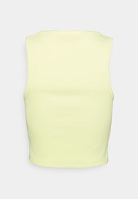 Ärmlös croptop i ljusgul, med en mjuk, stretchig bomullsblandning och en figursydd design samt en enkel rund halsringning.