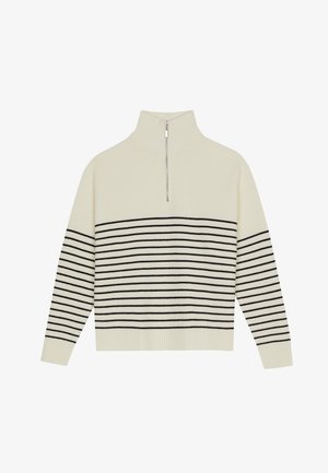 Kreemika värvi väljakutse kõrge kaelusega pullover, vertikaalse soonilise tekstuuriga ja horisontaalsete mustade triipudega kehas ja varrukatel. Hõbedane lukudetail.