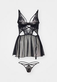 Svart blondekjole med prikkete mesh, som har et tettsittende liv, blomsterblonde-accents, og matchende svart stringtruse med stroppe-detaljer.
