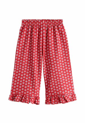Red elastic waist shorts with white and blue daisy pattern and ruffled hems on a plain white background.