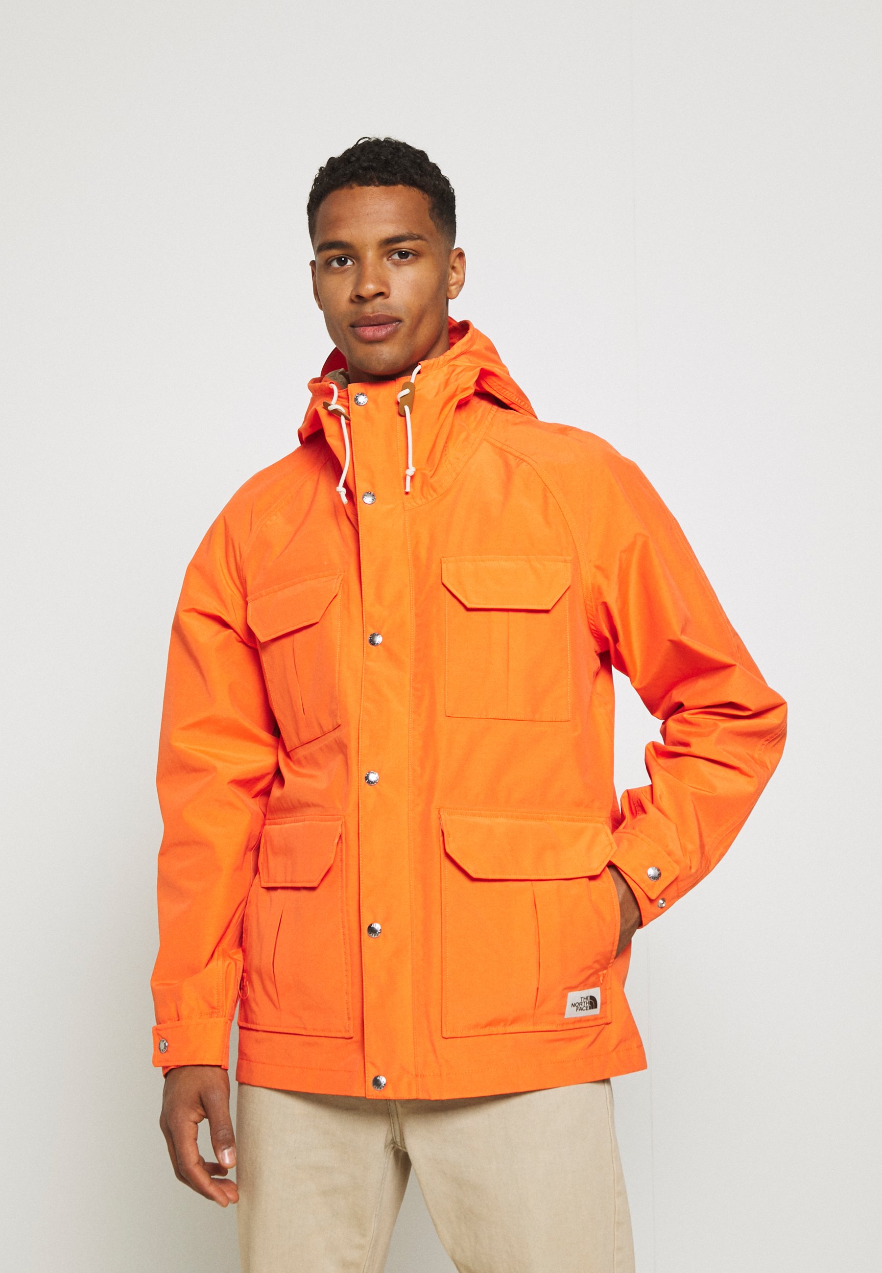 orange north face mountain jacket