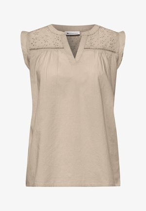 Beige hihaton pusero V-kaula-aukkolla, kukkakuviollisella rei'itetyllä kirjonnalla olkapäillä ja hieman röyhelöillä hartioissa.