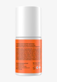 Contenitore cilindrico bianco con etichetta arancione contenente dettagli sul prodotto e ingredienti. Capacità di 6,5 ml. Il testo include istruzioni in più lingue.