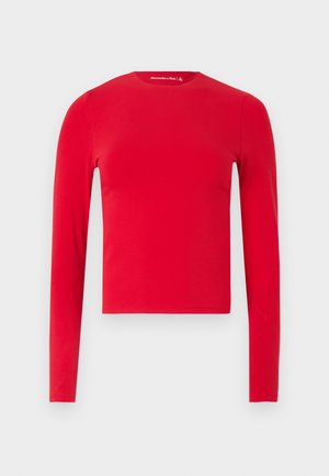 Red long-sleeve fitted crew neck crop top with smooth texture, displayed against a plain light background.