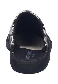 Black, low-profile slip-on shoe with a wool upper and a textured sole. Features white stitching along the edge and a soft interior lining.