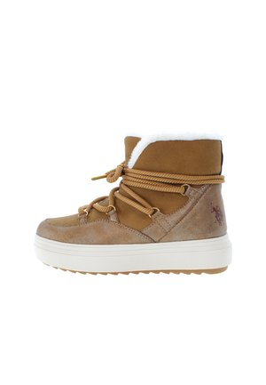 Brown suede ankle boots with white faux fur lining, brown laces, and a thick white sole. Features a logo detail on the side.
