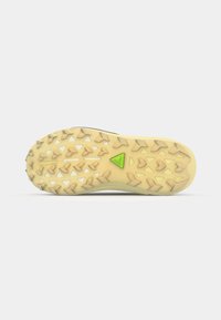 Sport shoe outsole with a textured rubber surface, featuring a yellow base, triangular grip patterns, and a green triangular accent.
