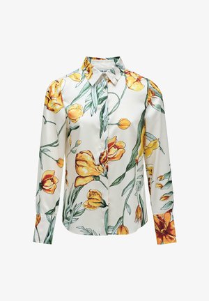 Blusa floral con cuello, mangas largas y fondo blanco. Decorada con patrones de tulipanes amarillos y hojas verdes.