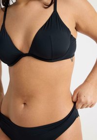 Svart bikiniset med en triangulär behå med justerbara band, mjukt material och en slät textur; brief med låg midja och resår.