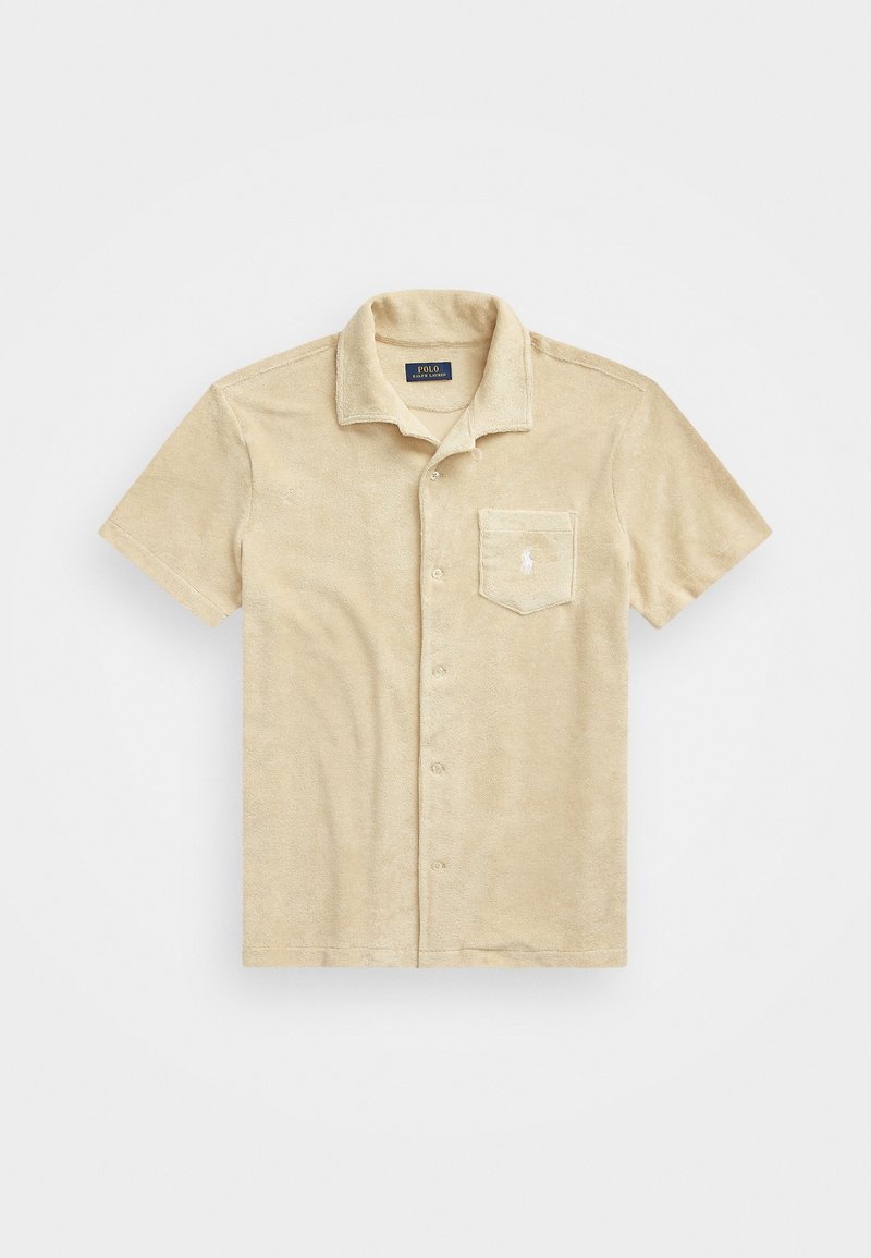 Tan short-sleeve shirt made of terry cloth with a button-up front, featuring a chest pocket and embroidered logo on the pocket.
