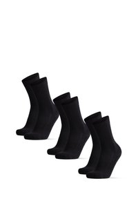 Chaussettes en coton noir avec des bords côtelés, présentées en rangée. Les chaussettes ont une texture lisse et un design classique avec des orteils renforcés. Quatre paires au total.