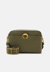 Green leather crossbody bag with a rectangular shape, gold hardware, a top zip, and a patterned strap featuring a logo.