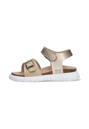 Beige kindersandaal met verstelbare gesp en klittenbandsluitingen, kurken voetbed, witte flexibele zool en turquoise klinknageldetails aan de zijkant.