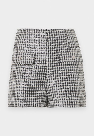Μινι φούστα σε μοτίβο μαύρου και άσπρου houndstooth με δύο εμπρόσθιες τσέπες με καπάκι και διακοσμητικά κουμπιά.
